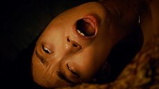 When Lucy enters the lab, unexpectedly encountering the cocoon, she screams as multiple tentacles break from the cocoon’s surface and drag her into its slimy chamber.